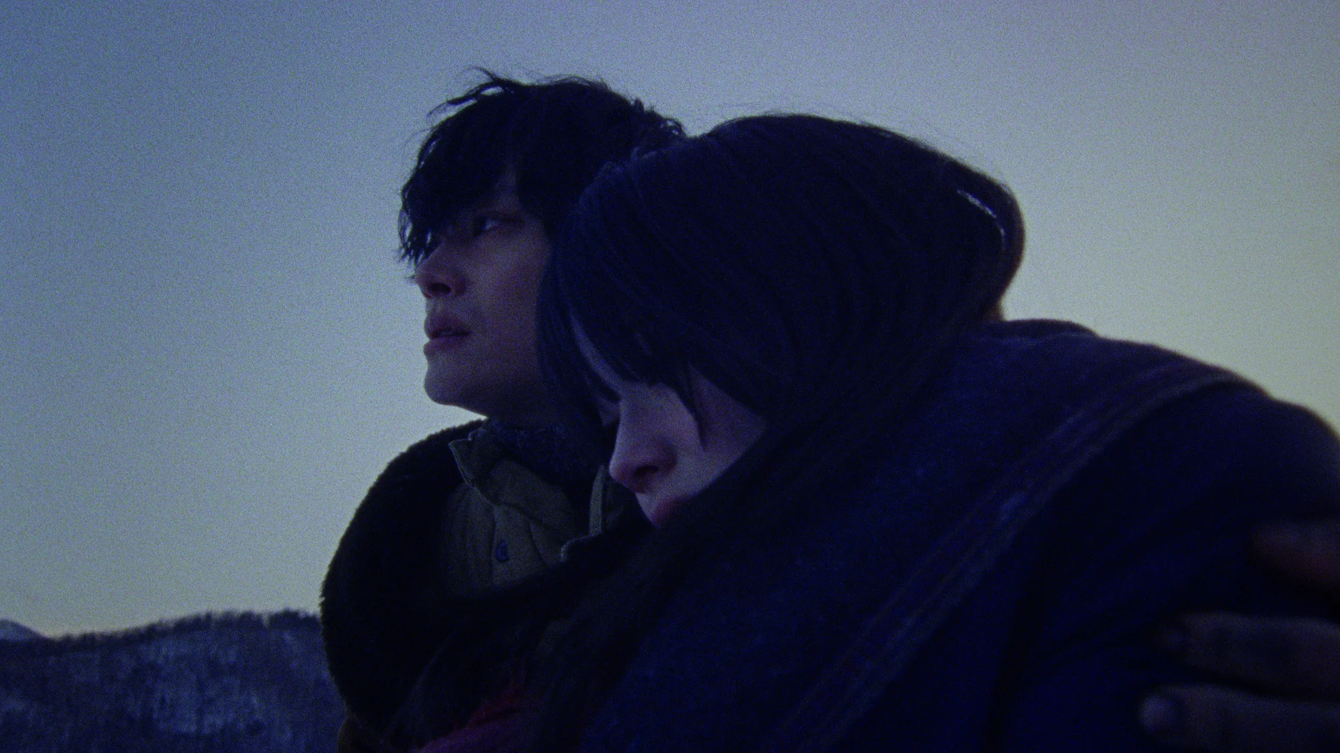 A young man and woman together in the cold