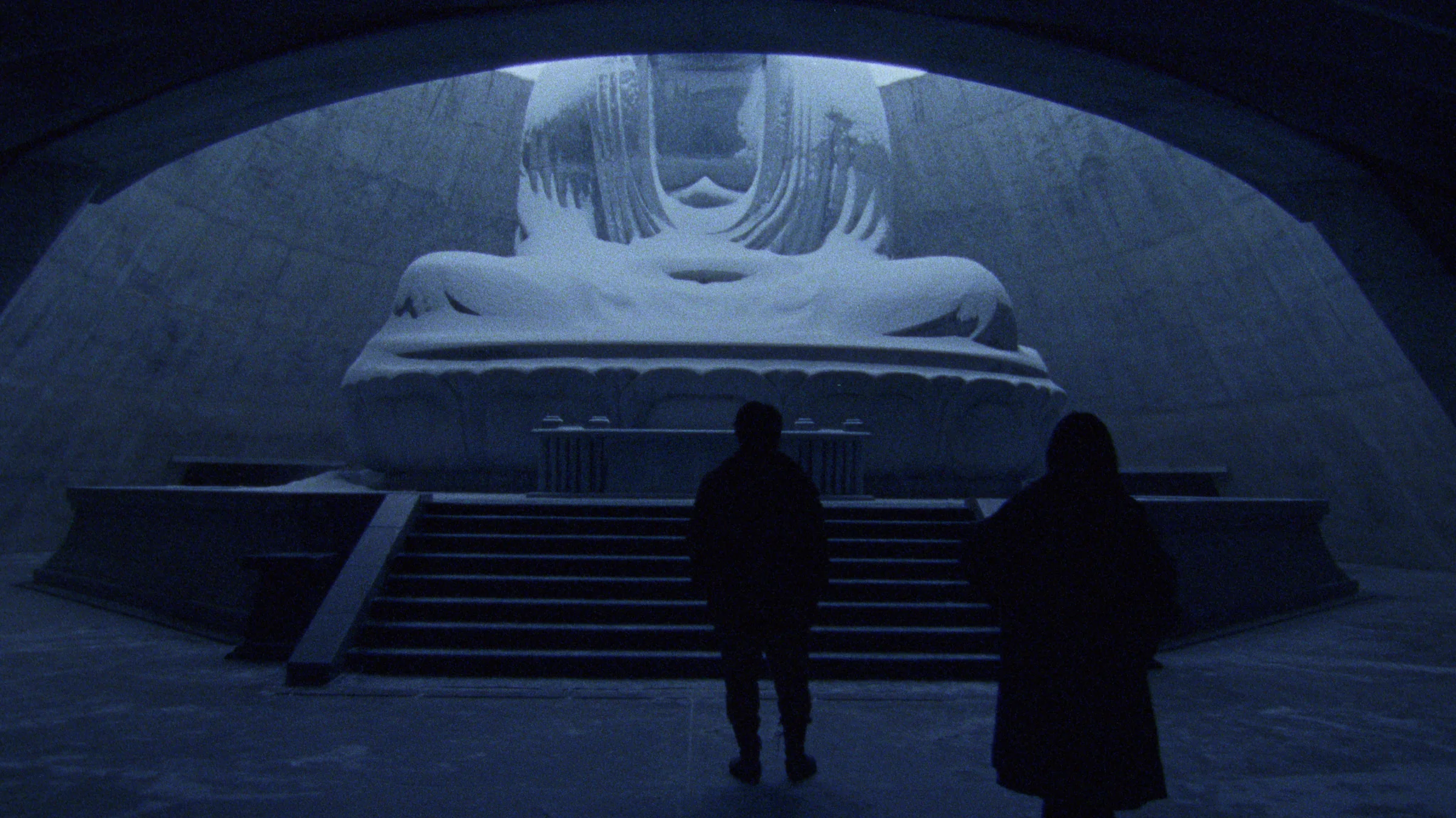 Two people in a snow-covered sanctuary